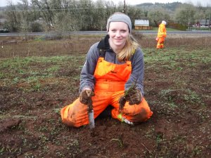 Brianna Sanders planting iris at Lupine Meadows