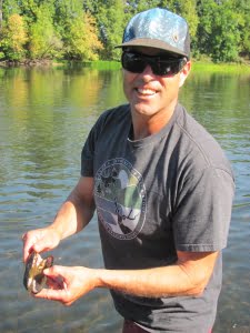 Teacher, Paul Bradley finds a muscle shell in the Willamette